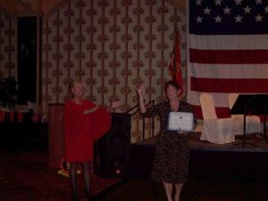 Lisa Michael accepting certificate from SgtMaj (ret) Pam Bloustine